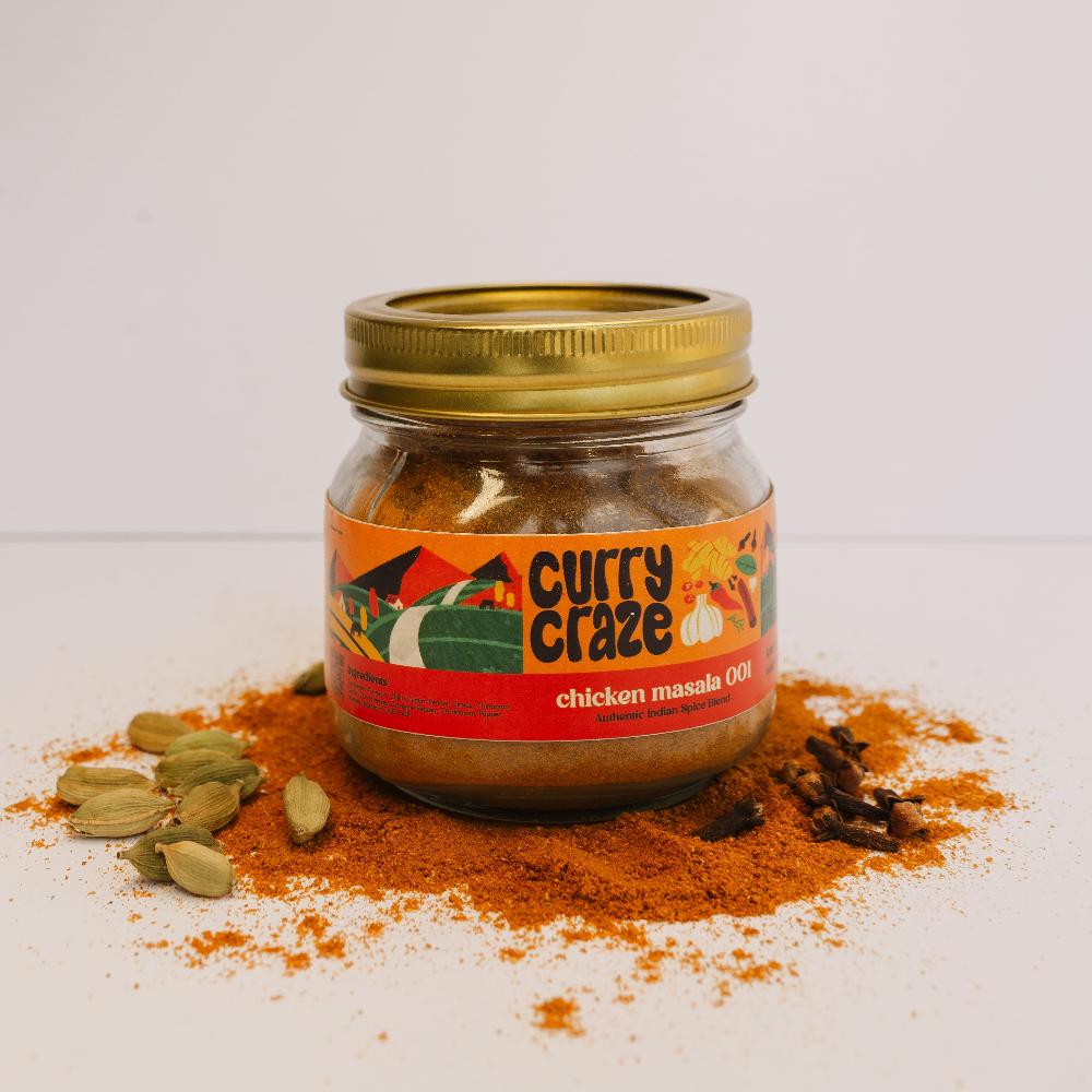 Curry Crazy chicken masala spice jar placed on a small white pedestal against a plain white background, highlighting the simplicity and focus on the brand's premium product."